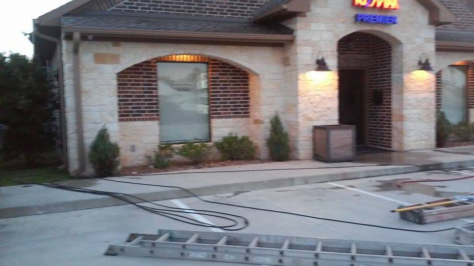 pressure washing the outside of real estate office and parking lot